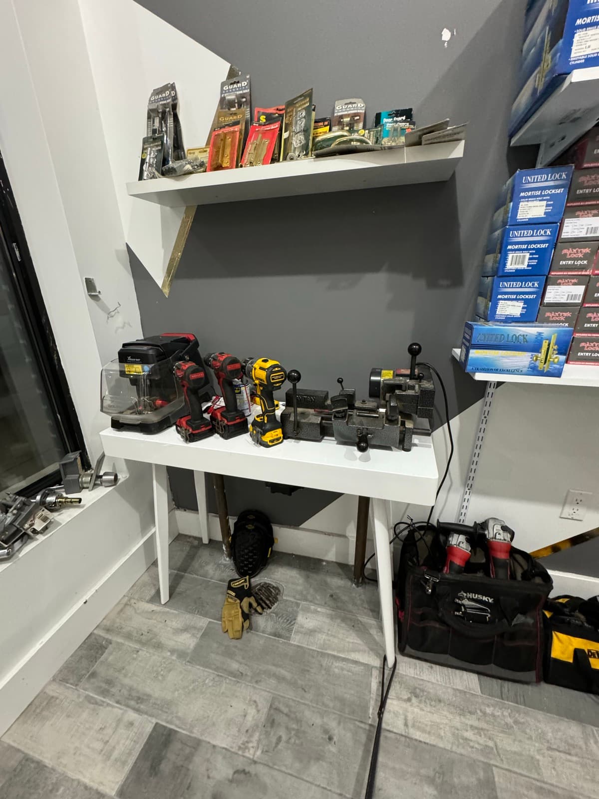 Key-cutting bench with duplicators and drills at the President St shop