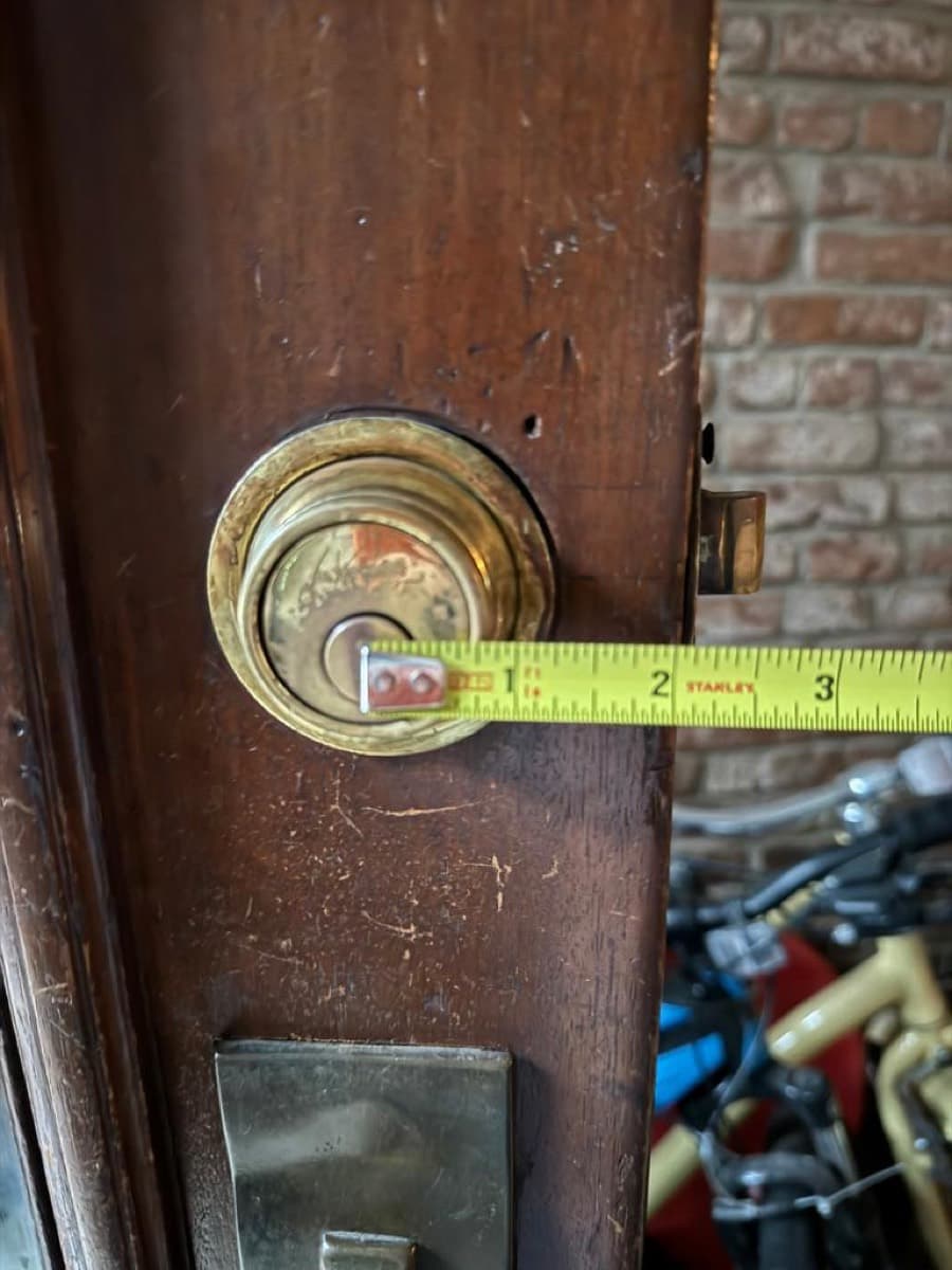 Measuring an antique mortise cylinder on a pre-war brownstone door